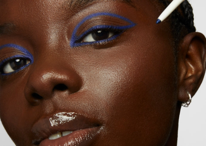 Model wears Milk Makeup Infinity Long Wear Eyeliner for a navy blue graphic eye