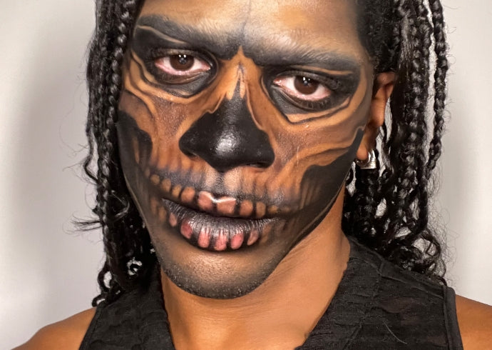 Content creator Jakobe Jay wears skeleton Halloween makeup using Milk Makeup Hydro Grip Primer and Milk Makeup Infinity Long Wear Eyeliner