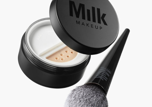 Jar of Milk Makeup Pore Eclipse Matte Setting Powder with the Pore Eclipse Powder Brush against a white background