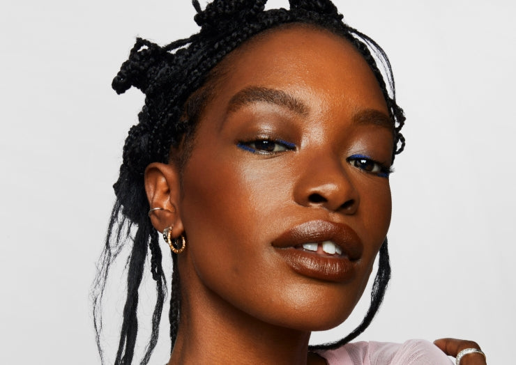 Model wears a full face of Milk Makeup products including Matte Bronzer against a white background