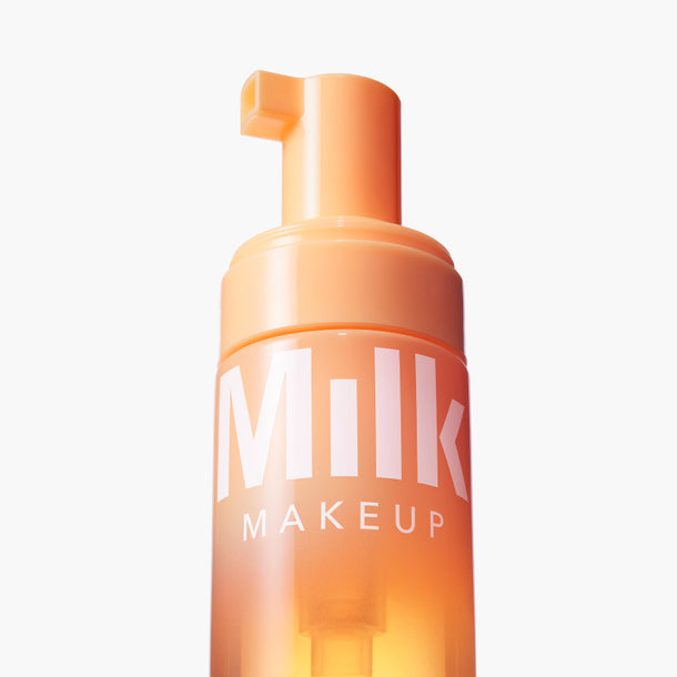 bottle of Milk Makeup Cloud Glow Priming Foam on a white background