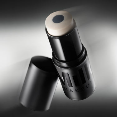 Product shot of Milk Makeup Pore Eclipse Matte Blur Stick against a black background