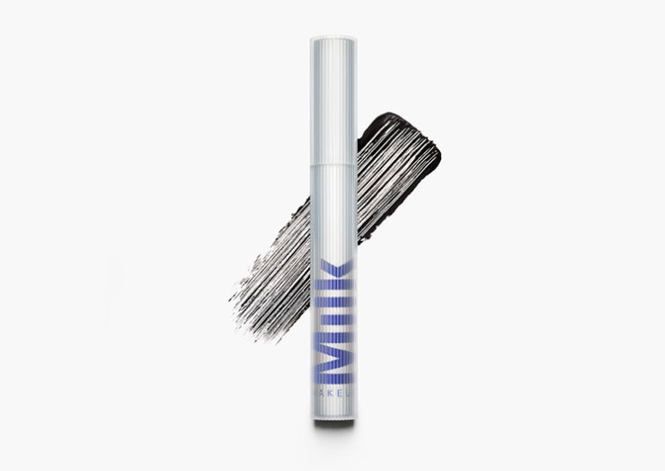 Product image of Milk Makeup RISE Waterproof Mascara with a swipe of mascara behind it on a white background.