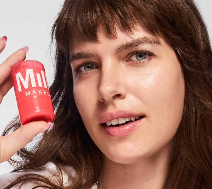 A model holds up Milk Makeup Watermelon Jelly Glow Serum